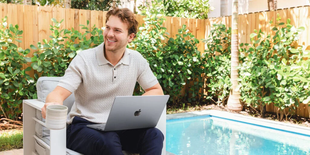 A customer using a MacBook outdoors